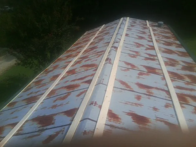 Rusted metal roof panels with new wood purlins before replacement — Storm Damage Roof Repair in Savannah by Roofing Brothers